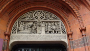 Sculpture above doorway the only remaining French Protestant Church in London, first established by royal charter in 1550 it now occupies  by Aston Webb erected between 1891–93 in Soho Square.